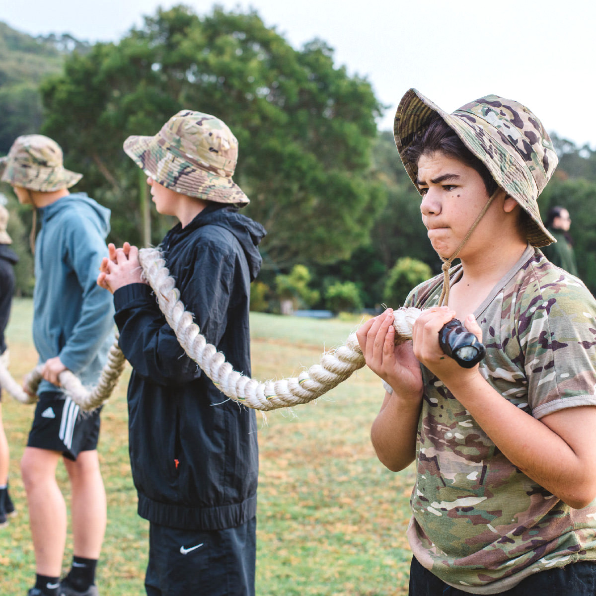 An image of boys learning teamwork and holding a rope