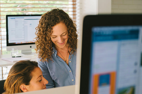 Two woman conversing about strategy