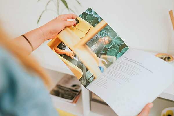 Woman holding a recently designed brochure