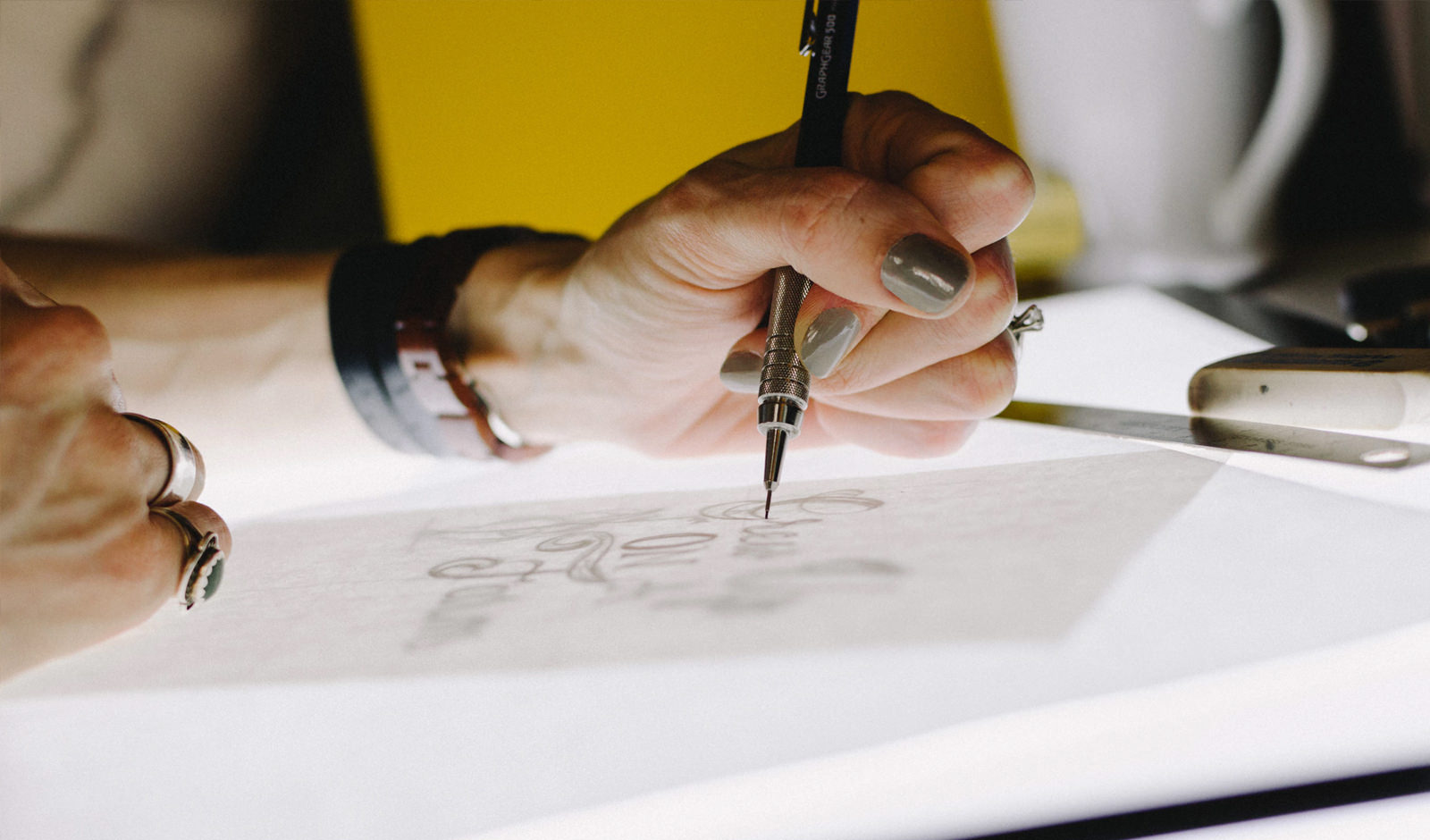 a close up image of a hand drawing on a lightbox