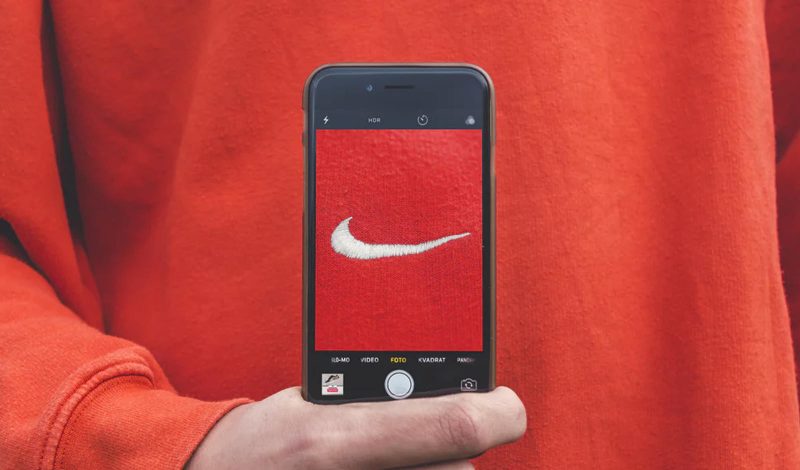 a mobile phone with the nike symbol on the screen