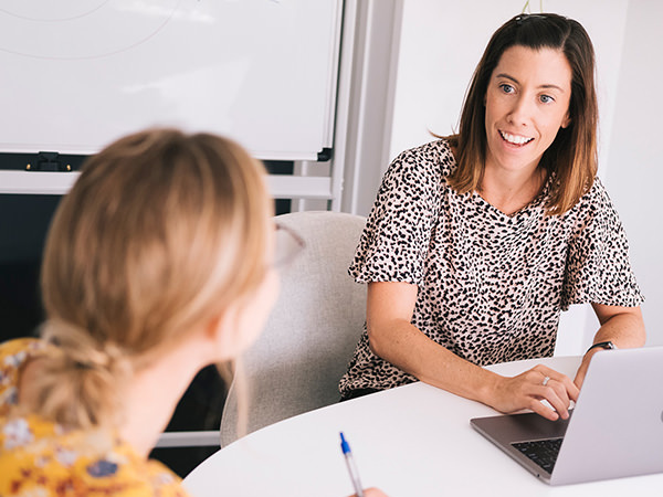 two woman talking during a marketing workshop